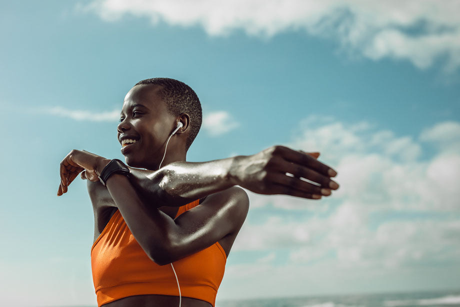 woman stretching wearing headphones