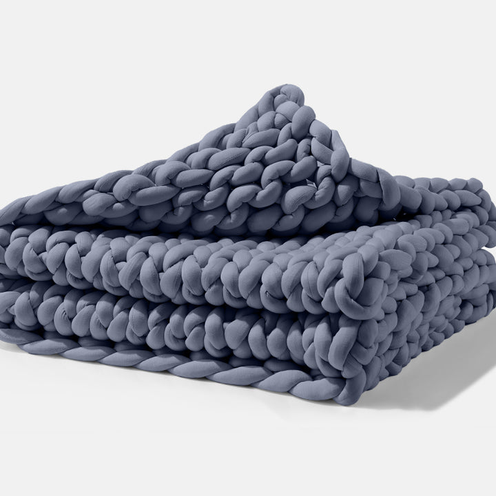 A folded Blueberry Gravity Weighted Chunky Knit Blanket - #color_blueberry