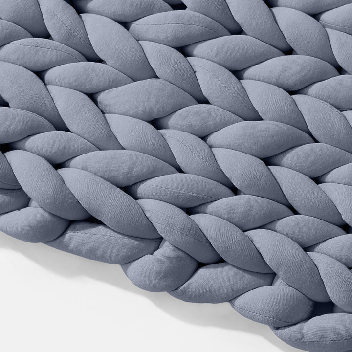Angled closeup on the texture of the Blueberry Gravity Weighted Chunky Knit Blanket - #color_blueberry