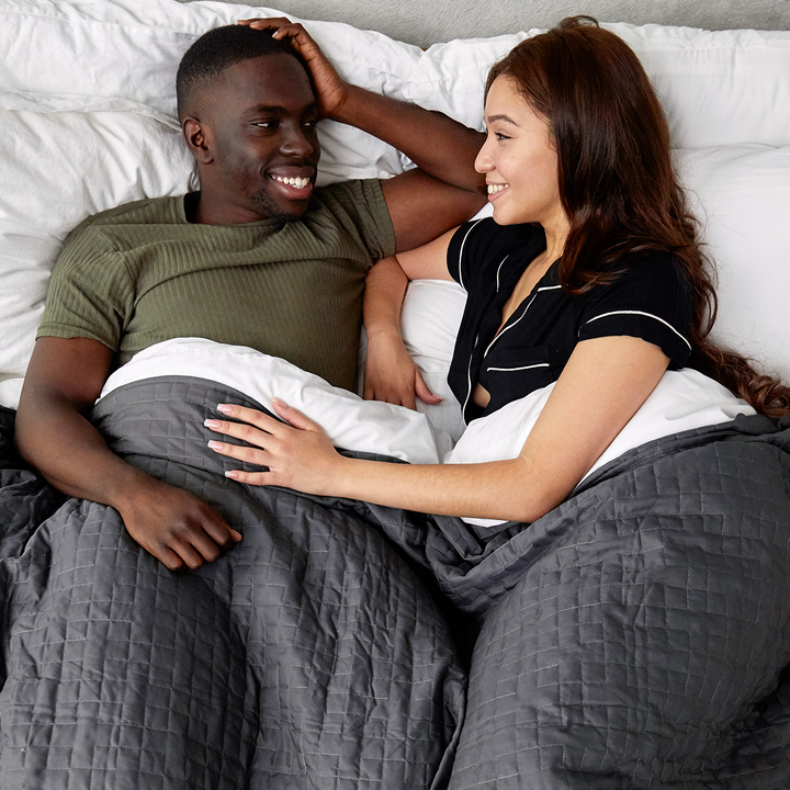 Couple laying under Grey Queen/King Cooling Blanket