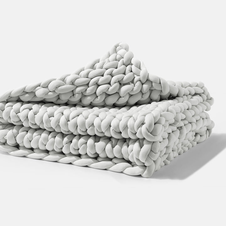 A folded Soft Grey Gravity Weighted Chunky Knit Blanket - #color_soft-grey