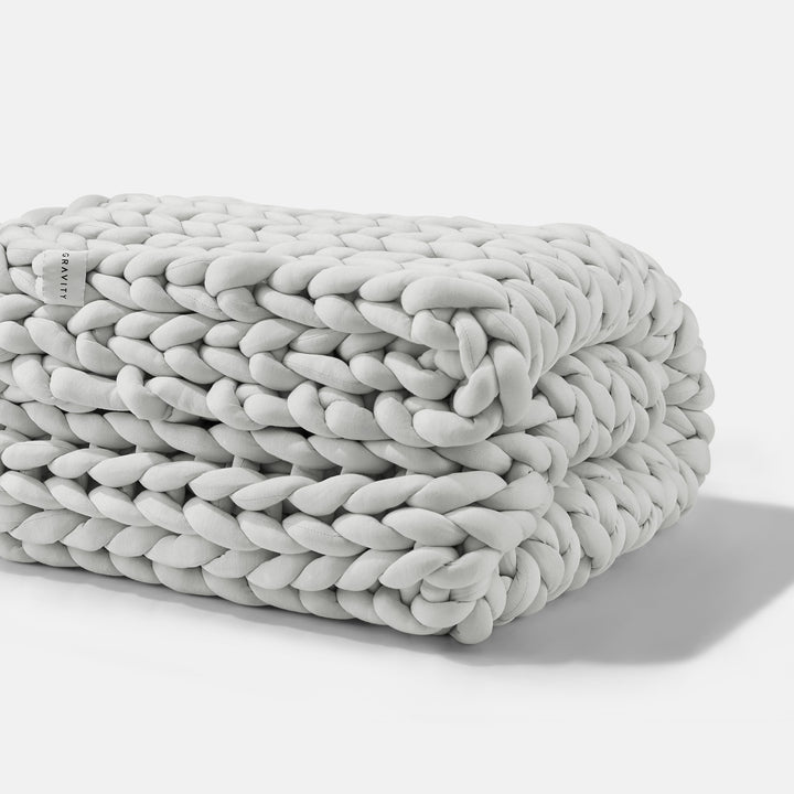 A folded Soft Grey Gravity Weighted Chunky Knit Blanket - #color_soft-grey