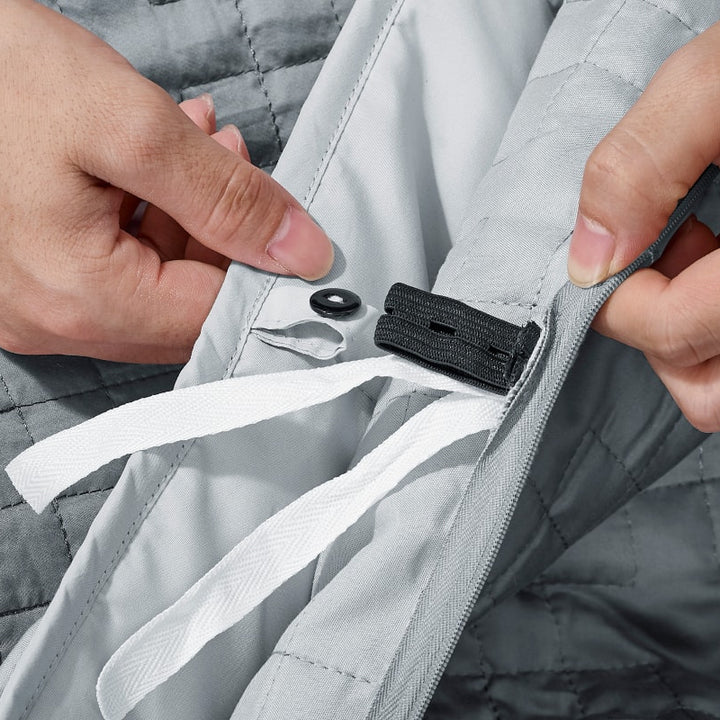 A button fastener shown on a Classic Grey Gravity Weighted Cooling Blanket - #color_classic-grey