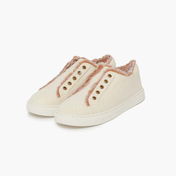 Off white faux fur lined slippers set against a white backdrop #color_off-white