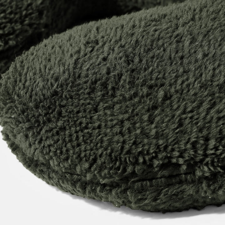 Closeup on the texture of a Black Gravity Weighted Neck Pillow on a white background - #color_black