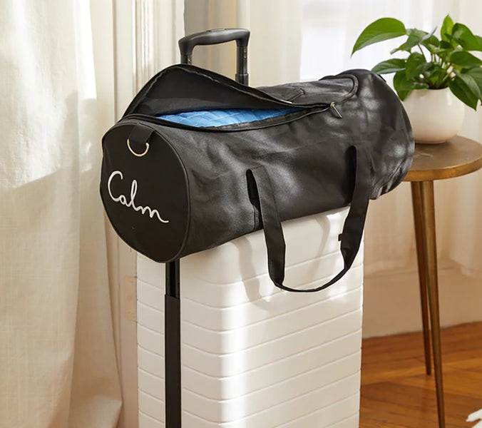 a duffel bag with a rolled up weighted blanket
