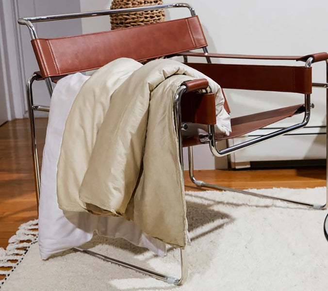 a weighted blanket hanging off of a chair