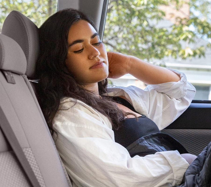 a woman asleep in her car
