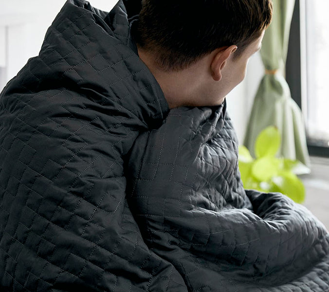 man wrapped in gravity blanket