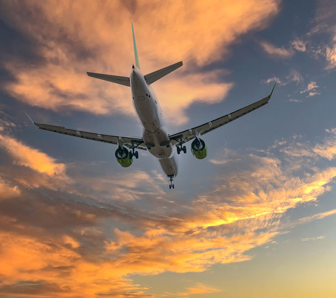plane flying during sunset