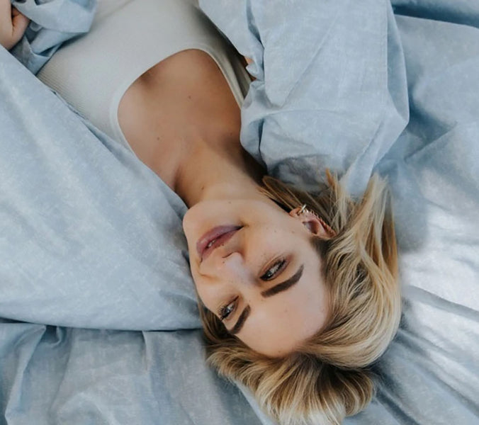smiling woman lying in bed