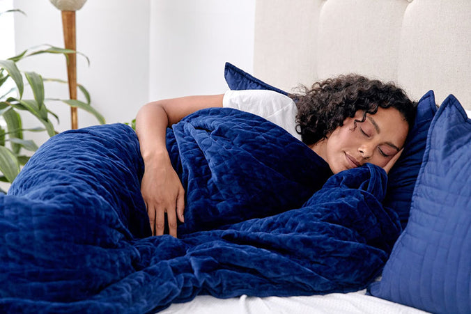 woman sleeping with gravity blanket