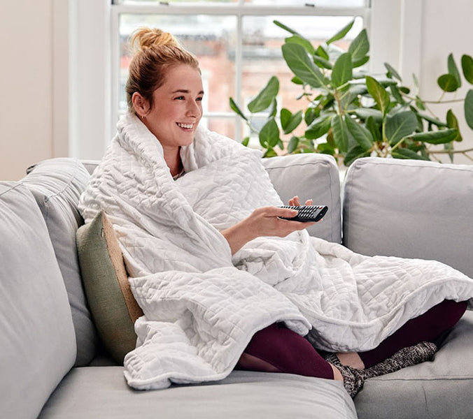 woman using white weighted blanket